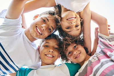 Buy stock photo Portrait, low angle and a group of happy siblings or huddled together or hug in solidarity and smiling outdoors. Circle, brothers and sisters or excited children play or bonding and face outside