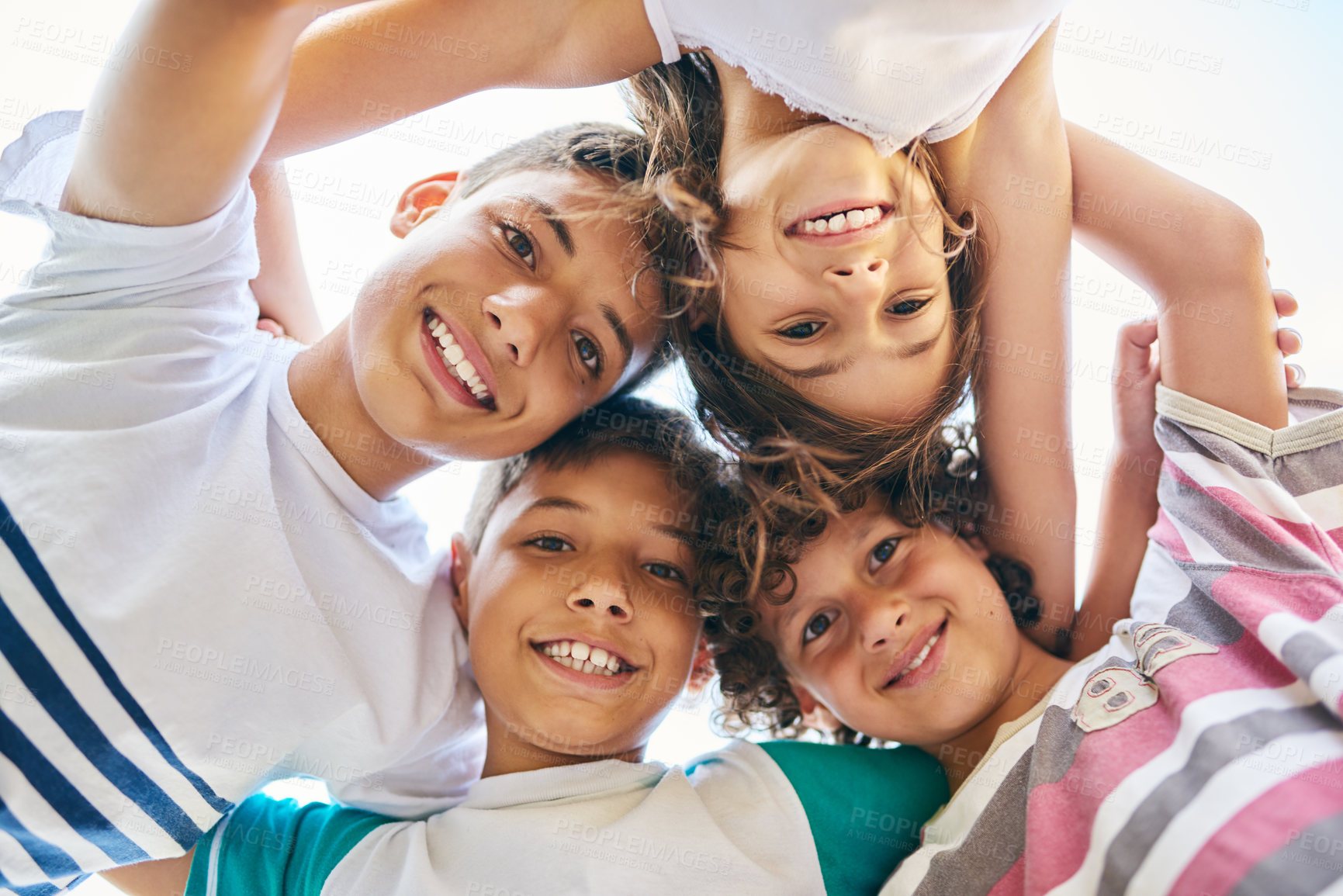 Buy stock photo Portrait, low angle and a group of happy siblings or huddled together or hug in solidarity and smiling outdoors. Circle, brothers and sisters or excited children play or bonding and face outside