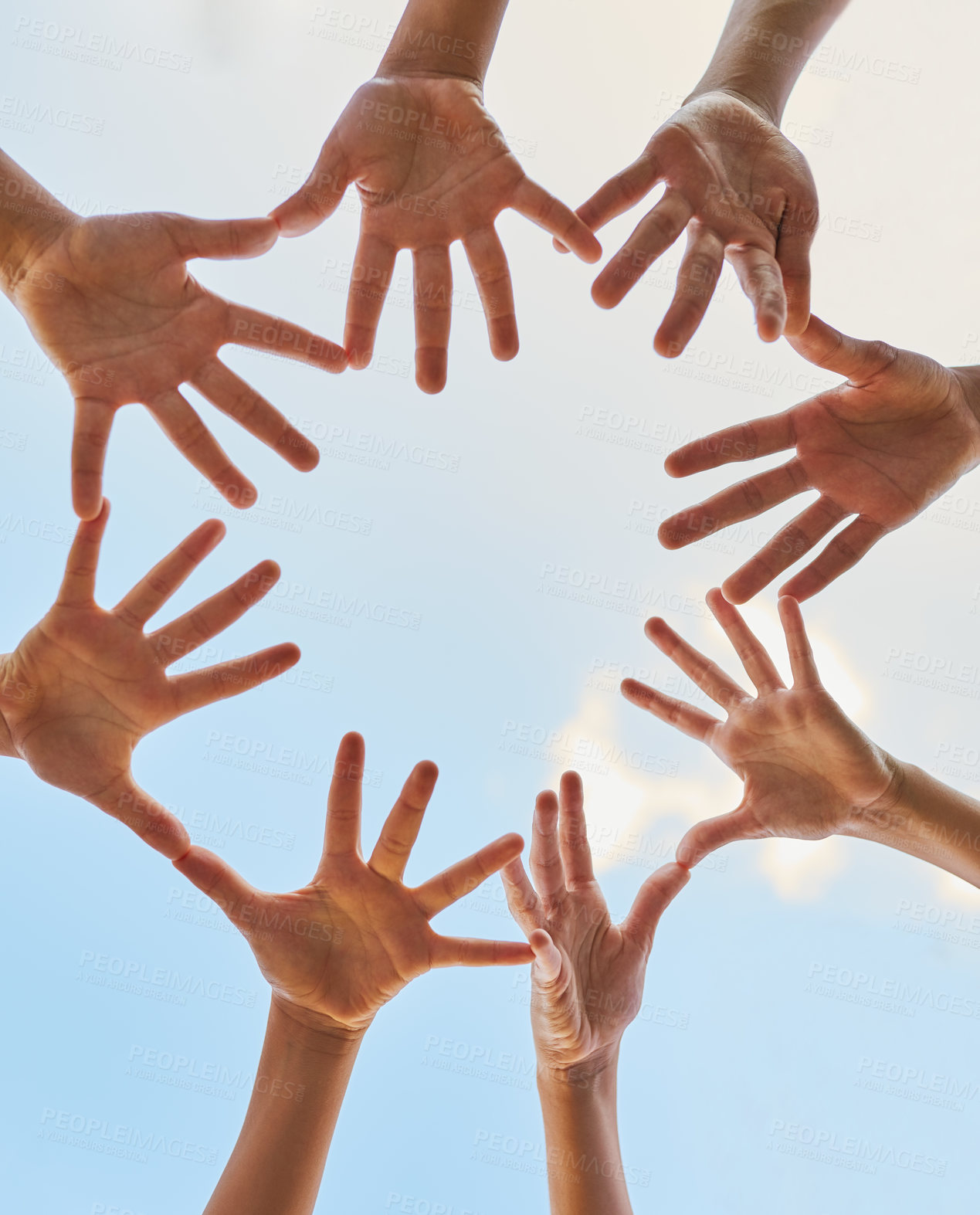 Buy stock photo Low angle shot of a group of children joining their hands together outdoors