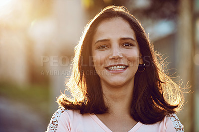 Buy stock photo Portrait of an attractive and happy young woman standing outside