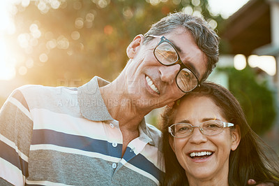Buy stock photo Portrait of an affectionate mature couple standing together in their backyard