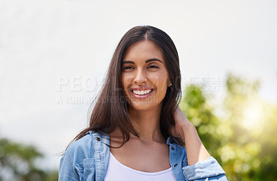 Buy stock photo Cropped shot of an attractive young woman standing outdoors