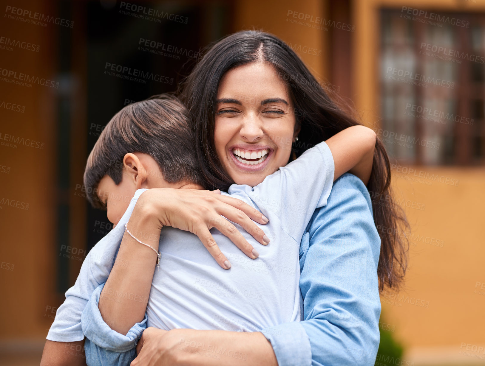 Buy stock photo Cropped shot of a young woman and her adorable son embracing in their backyard