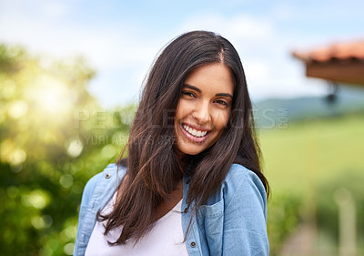 Buy stock photo Cropped portrait of an attractive young woman standing outdoors