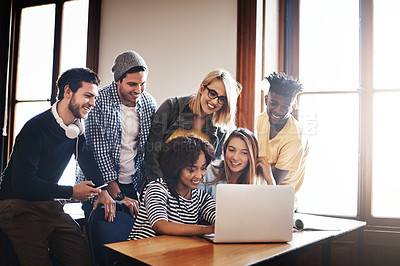 Buy stock photo Cropped shot of a group of university students working on an assignment together in class