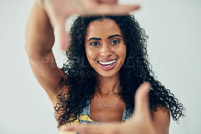 Buy stock photo Happy woman, portrait and finger with frame for picture, photography or memory on a white studio background. Young female person or model with smile in fashion for social media, capture or moment