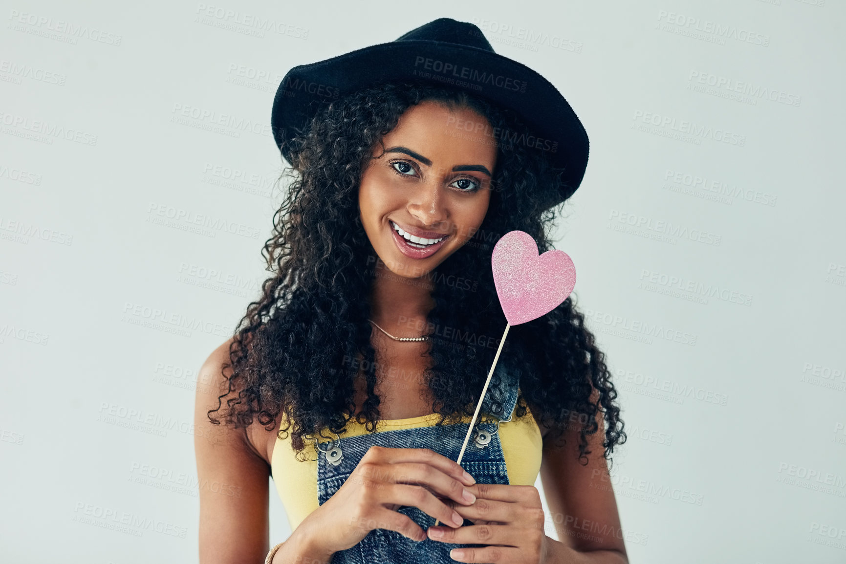 Buy stock photo Woman portrait, love and studio with heart paper, confident and romance emoji by white background. Female person, fashion vote and icon for kindness or support, smile and symbol for review in Brazil