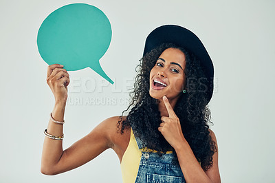 Buy stock photo Studio shot of an attractive young woman holding a speech bubble against a grey background
