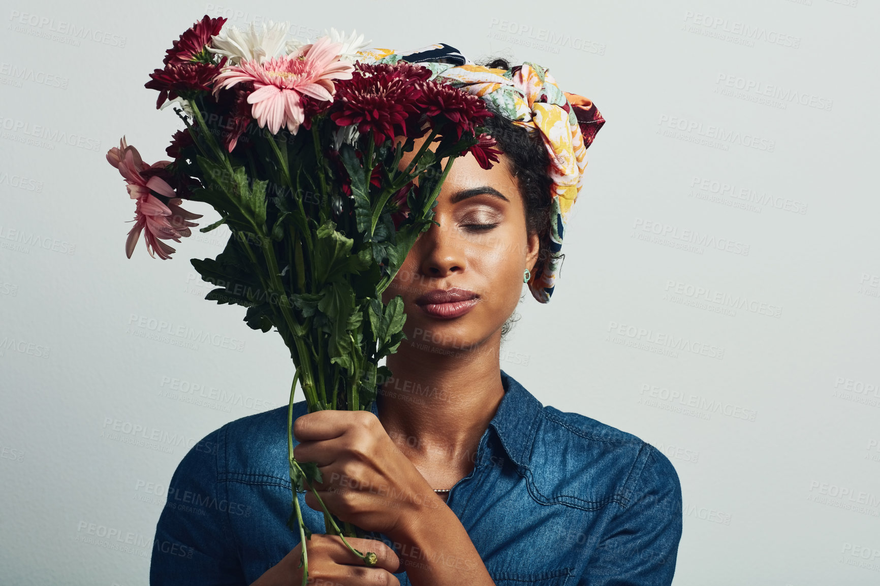 Buy stock photo Relax, flowers and smell with woman in studio for gift, satisfaction and spring fashion. Smile, happy and trendy floral present with model and bouquet isolated on gray background for natural aroma