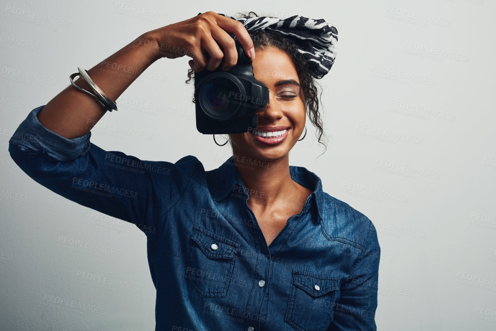 Buy stock photo Camera, woman and photographer in studio with smile for creative photography career for media. Art, paparazzi and person from Brazil with dslr equipment for magazine photoshoot by gray background.