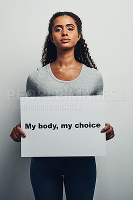 Buy stock photo Studio shot of an attractive young woman holding a placard that reads 