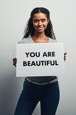 Buy stock photo Smile, woman and poster with text in studio for positivity, motivation and self expression on white background. Female person, portrait and placard with message for activism, pride and empowerment