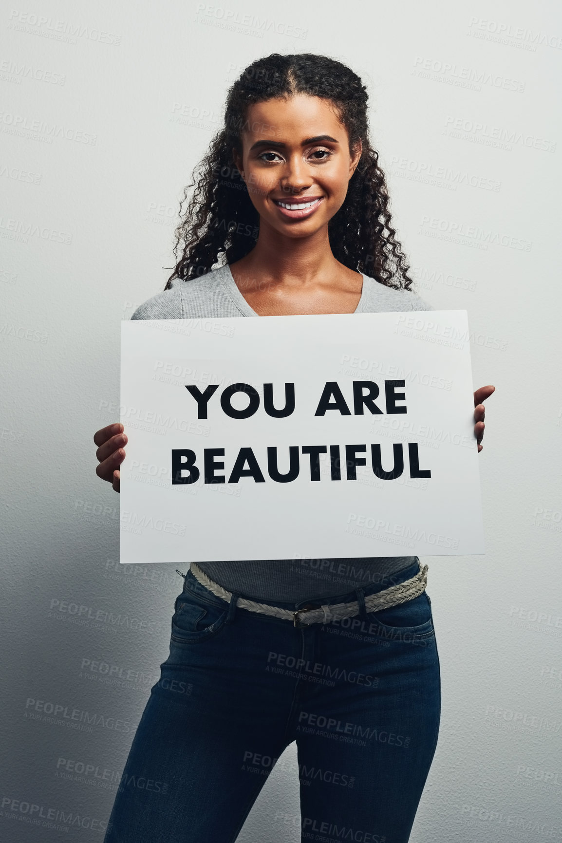 Buy stock photo Smile, woman and poster with text in studio for positivity, motivation and self expression on white background. Female person, portrait and placard with message for activism, pride and empowerment