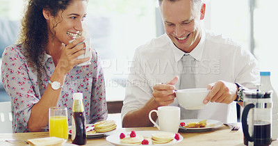 Buy stock photo Shot of a happy middle aged couple having breakfast together in the morning at home
