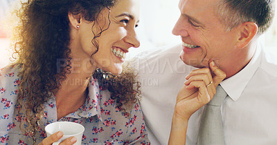 Buy stock photo Shot of an affectionate middle aged couple having coffee together in the morning at home