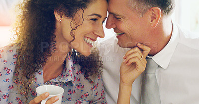 Buy stock photo Shot of an affectionate middle aged couple having coffee together in the morning at home