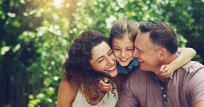 Buy stock photo Shot of an affectionate little girl spending quality time with her mother and father outdoors