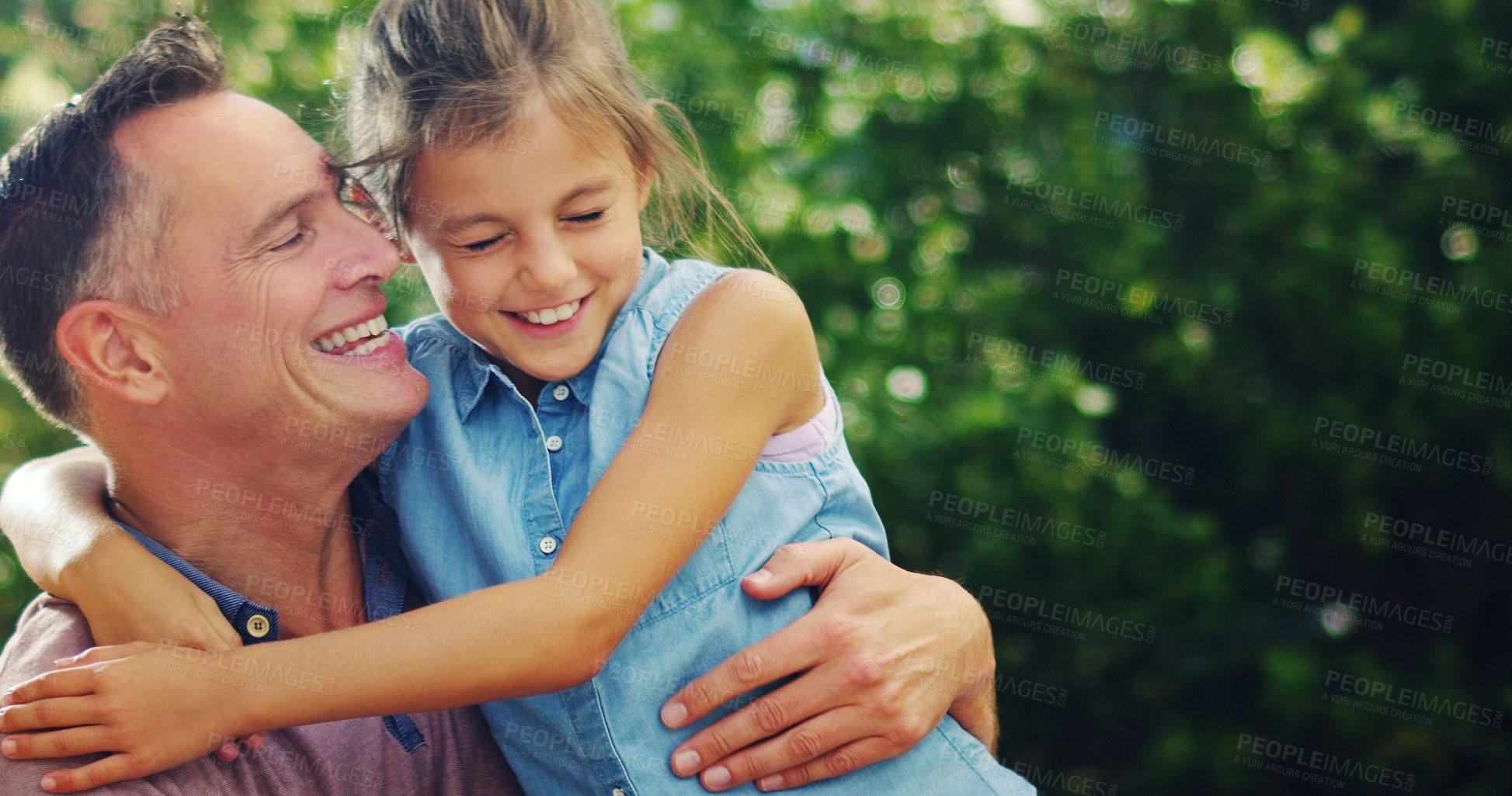 Buy stock photo Shot of an affectionate little girl spending quality time with her father outdoors
