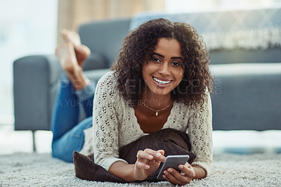 Buy stock photo Shot of an attractive young woman using a cellphone at home