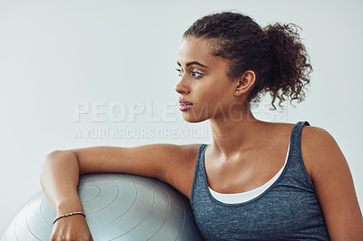 Buy stock photo Studio shot of an attractive young woman taking a break during a workout against a grey background