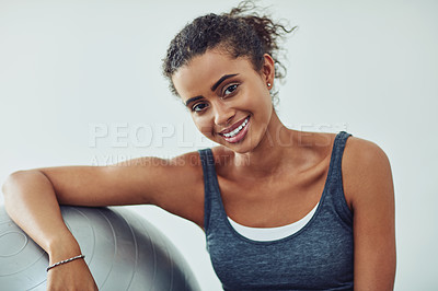 Buy stock photo Studio shot of an attractive young woman taking a break during a workout against a grey background