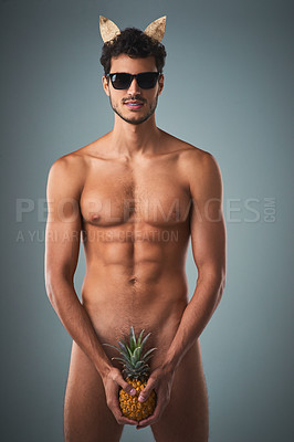 Buy stock photo Studio shot of a handsome young shirtless man posing against a grey background