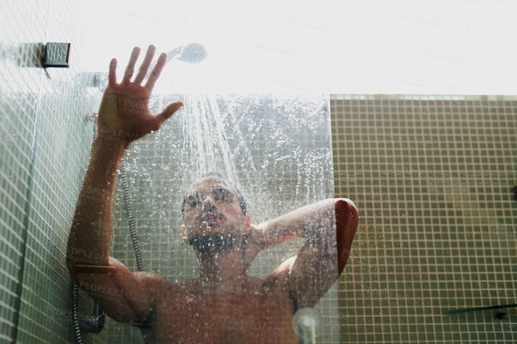 Buy stock photo Cropped shot of a handsome young man having a refreshing shower at home