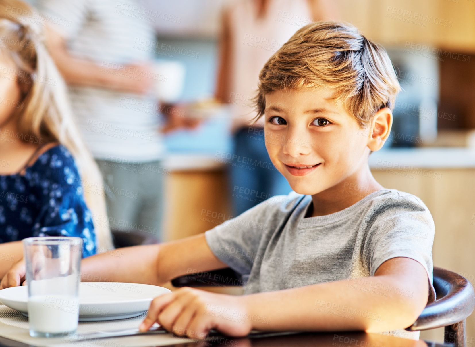Buy stock photo Portrait of a young boy sitting at the breakfast table at home