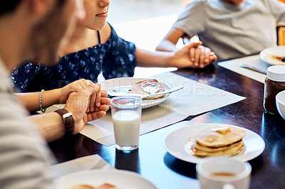 Buy stock photo Closeup shot of a family praying before enjoying their meal together at home