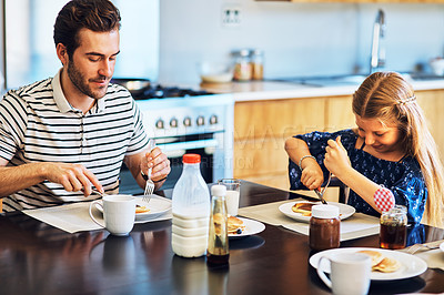 Buy stock photo Dad, daughter and breakfast in kitchen, morning and eating in house, hungry and smile for pancakes. Home, girl and father in dining room, healthy and food on table, nutrition and ready for school