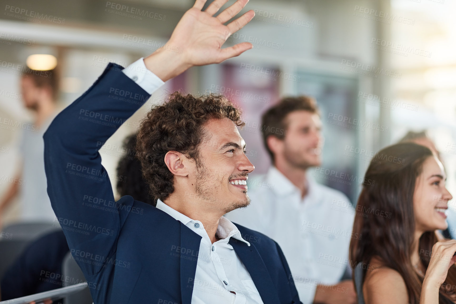 Buy stock photo Cropped shot of a handsome young businessman raising his hand during a seminar