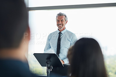 Buy stock photo Podium, mature man and smile in seminar, speaker and audience in event, training and presentation in boardroom. Workshop, speech and talking in conference, entrepreneurship and masterclass for group