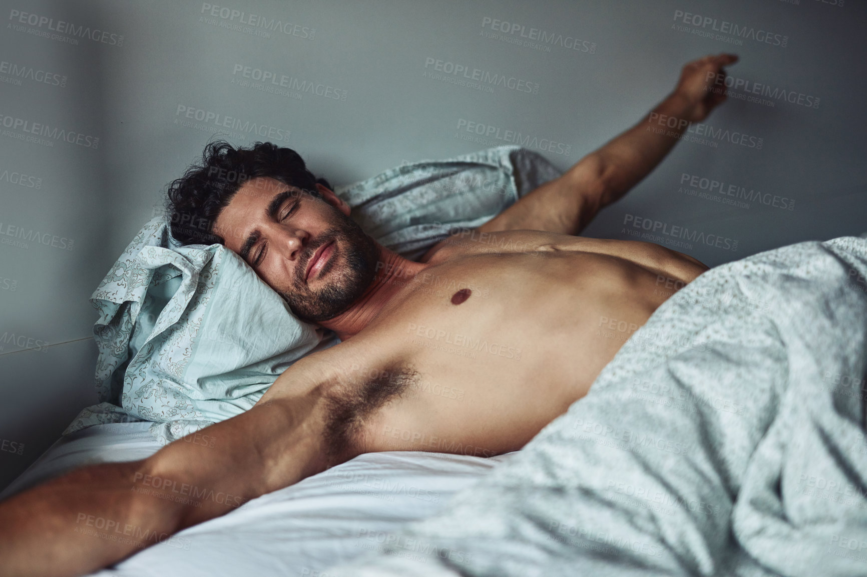 Buy stock photo Cropped shot of a handsome young shirtless man waking up at home