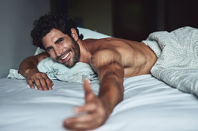 Buy stock photo Cropped shot of a handsome young shirtless man lying in bed at home