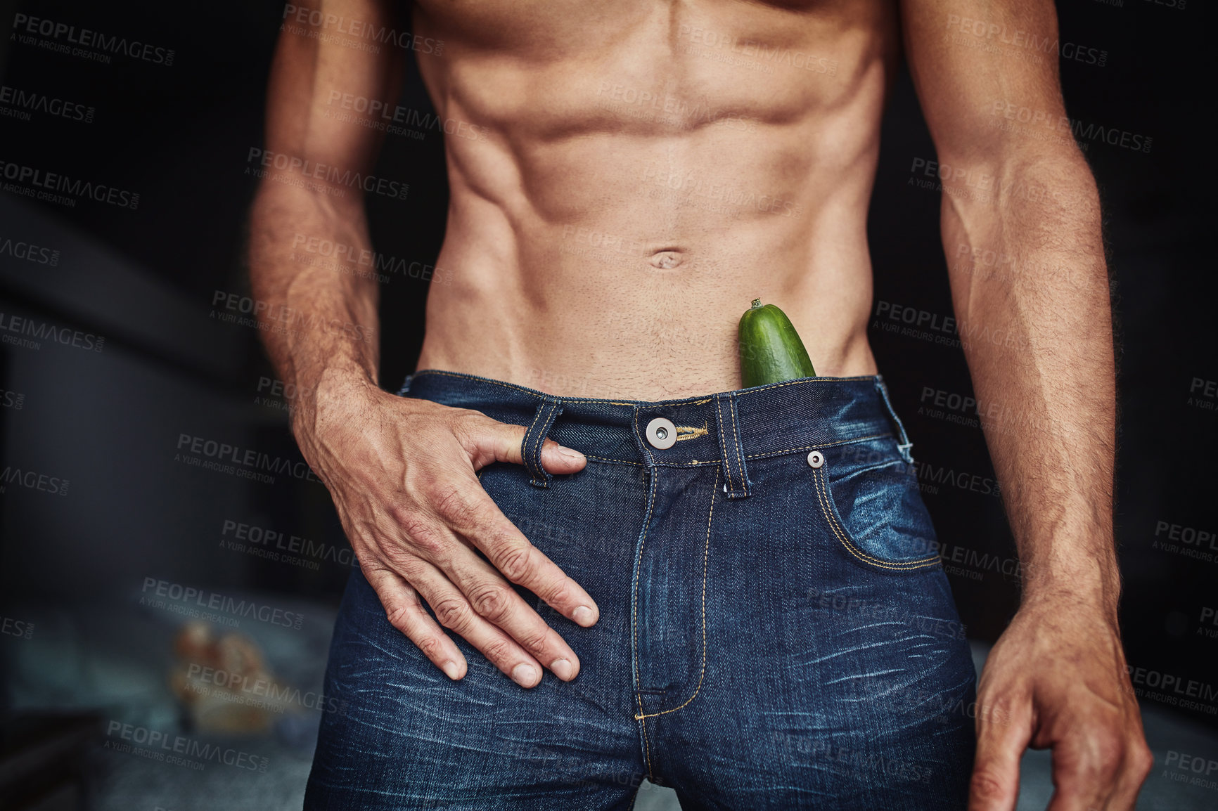 Buy stock photo Cropped shot of an unrecognizable shirtless man with a cucumber in his pants at home