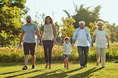 Buy stock photo Holding hands, love and smile with big family in garden of home together for bonding or visit. Senior people, parents and children walking outdoor on lawn of backyard for relationship in summer