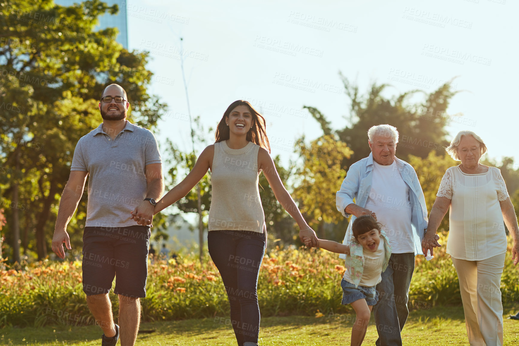 Buy stock photo Shot of a happy family going for a walk together in the park