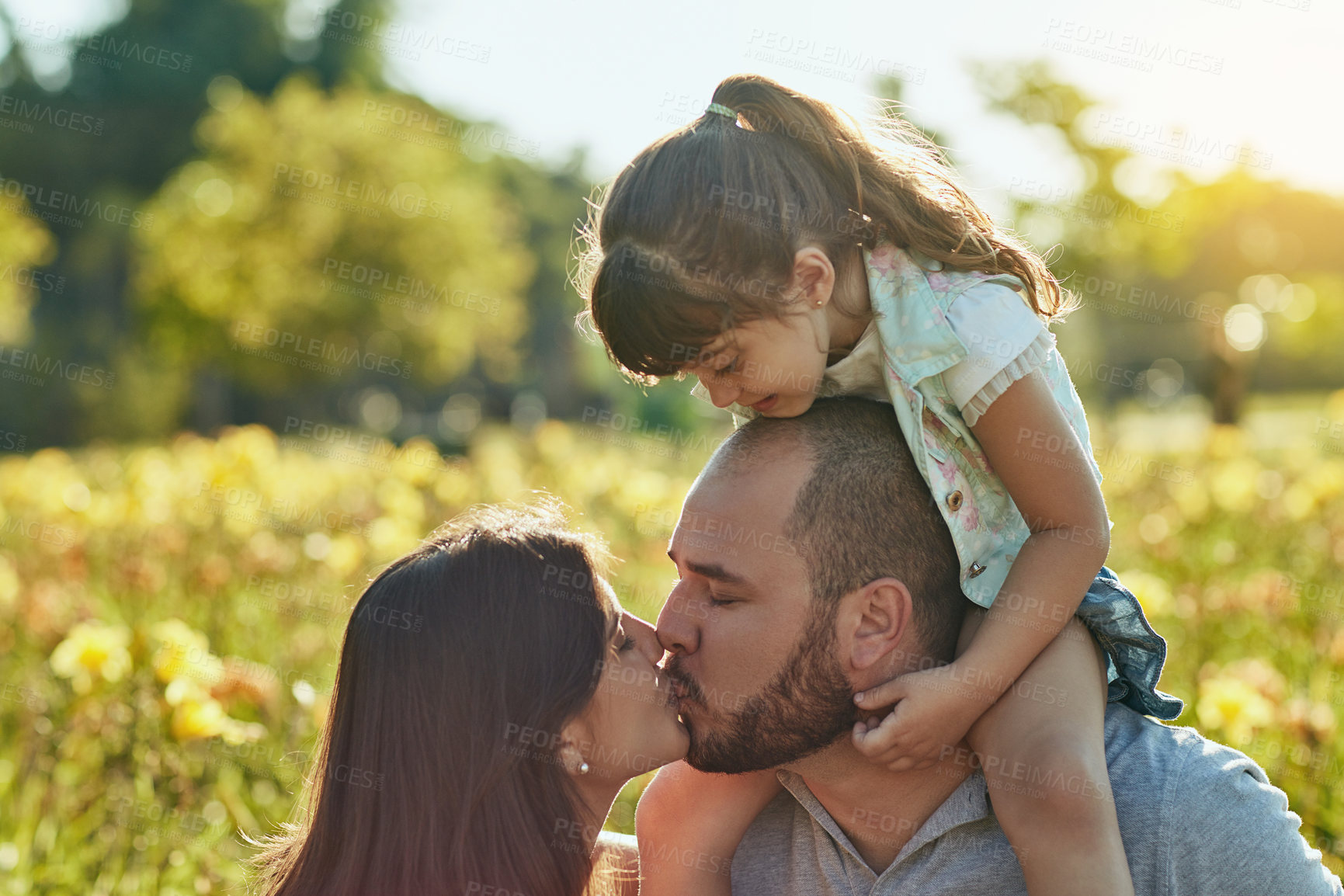 Buy stock photo Mom, kiss and girl on shoulders of dad outdoor in nature together for family bonding, love or relationship. Mother, father and child in countryside or park for holiday, travel and vacation in spring