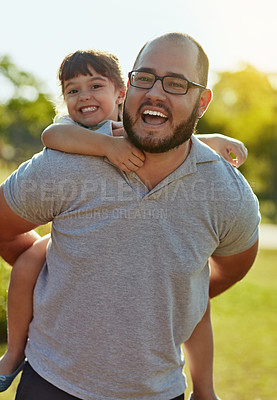 Buy stock photo Shot of an adorable little girl and her father enjoying a piggyback ride in the park