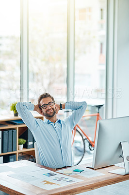 Buy stock photo Portrait of a young businessman taking a break while working in an office