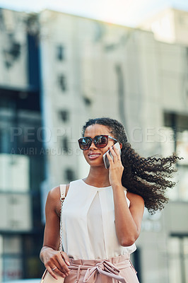 Buy stock photo Shot of an attractive young woman on a call in the city