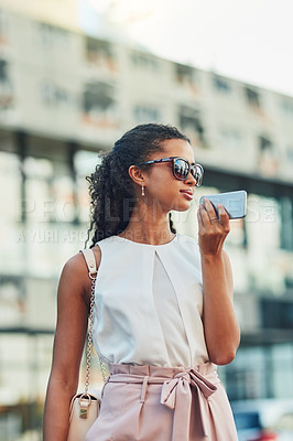 Buy stock photo Shot of an attractive young woman on a call in the city
