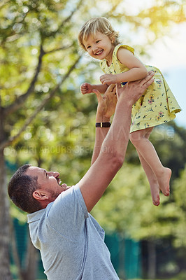Buy stock photo Shot of a father bonding with his little daughter outdoors