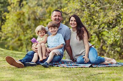 Buy stock photo Portrait of a happy family bonding together outdoors