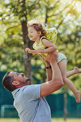 Buy stock photo Happy dad, child and lifting with nature for bonding, holiday or weekend together at park. Father, daughter or little girl with smile for love, care or support in air for fun playing or childhood