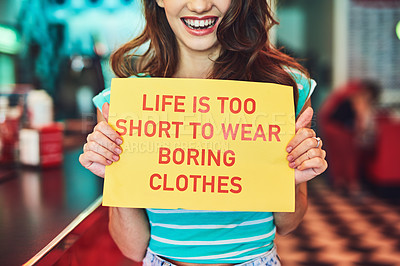 Buy stock photo Cropped shot of an unrecognizable young woman holding up a sign in a retro diner