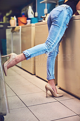 Buy stock photo Legs, chores and person in laundry room, routine and loading in washing machine, high heels and cleaning. Fashion, busy and detergent in laundromat, shoes and casual style on weekend and woman