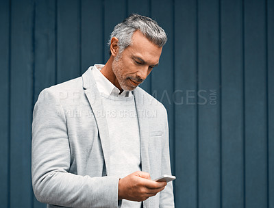 Buy stock photo Phone, wall and business man reading email for real estate investment outdoor. Mobile, scroll and mature professional on app for property management, mortgage review or financial loan online by space