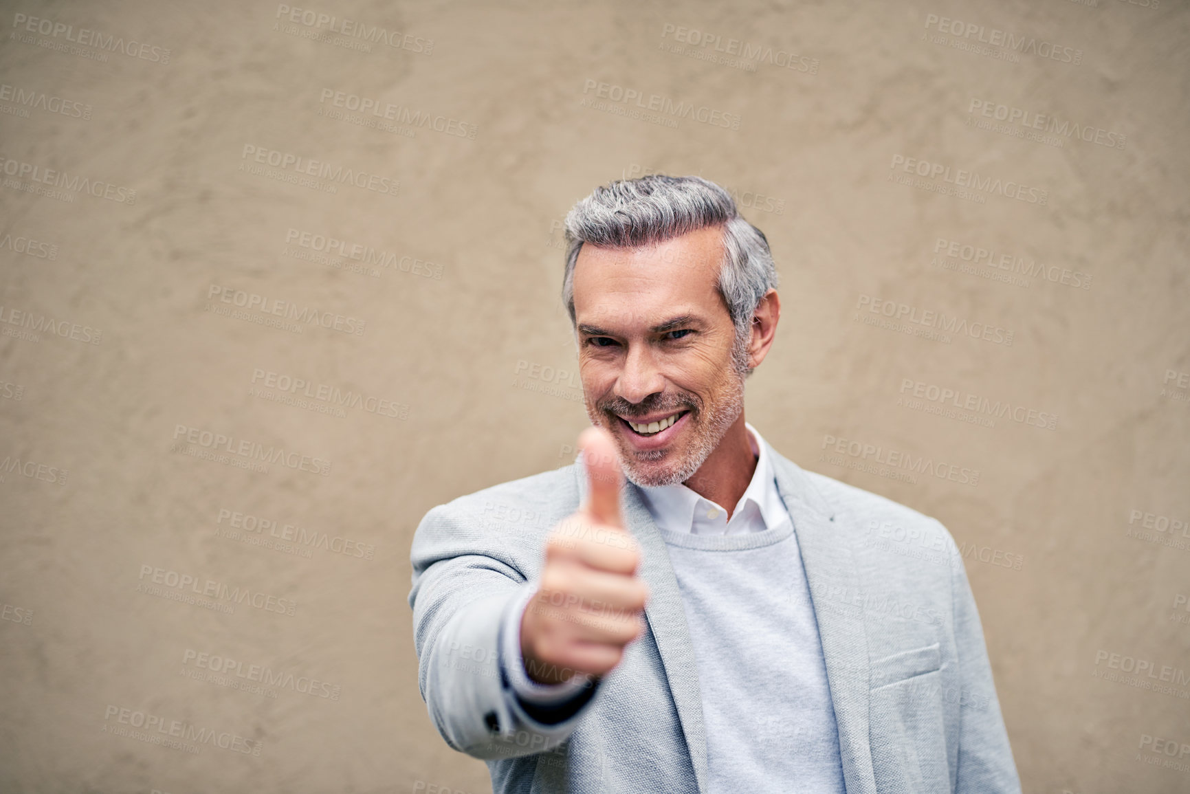 Buy stock photo Cropped shot of a smartly dressed mature businessman showing thumbs up outside