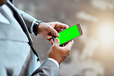 Buy stock photo Closeup shot of an unrecognizable businessman using a cellphone with a screen green in an office